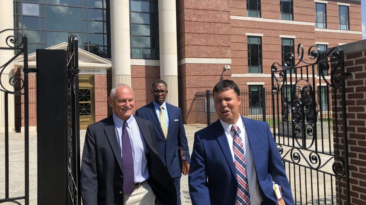 Thomas Brock (left) leaves federal court after a hearing last year with his lawyers, Ed Givens (center) and Ravi Sanyal