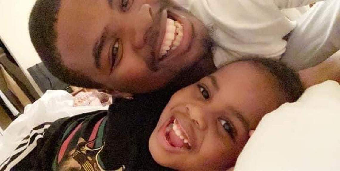 Rayjon Smith, pictured here with one of his three children. The third was born after Smith’s death on Feb. 13, 2022.