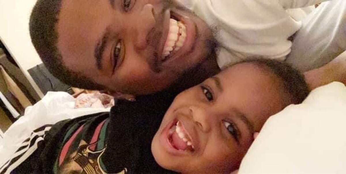 Rayjon Smith, pictured here with one of his three children. The third was born after Smith’s death on Feb. 13, 2022.