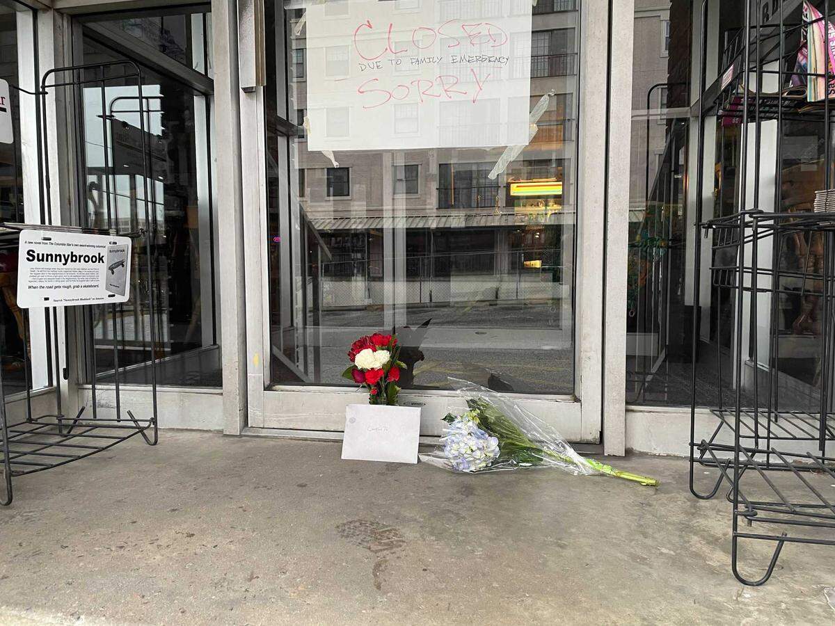 Flowers sit outside Andy’s Deli in Five Points on Friday morning, after longtime owner Andy Shlon died.