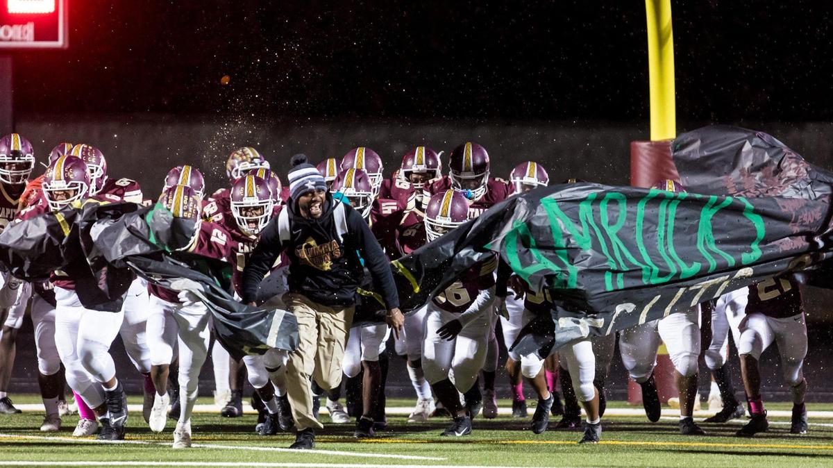 Columbia Capitals players make their entrance in the rain before the game against the Eau Claire Shamrocks.