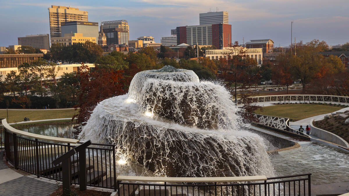 The downtown Columbia skyline shines beyond the fountain at Finlay Park on Thursday, Nov. 20, 2025.