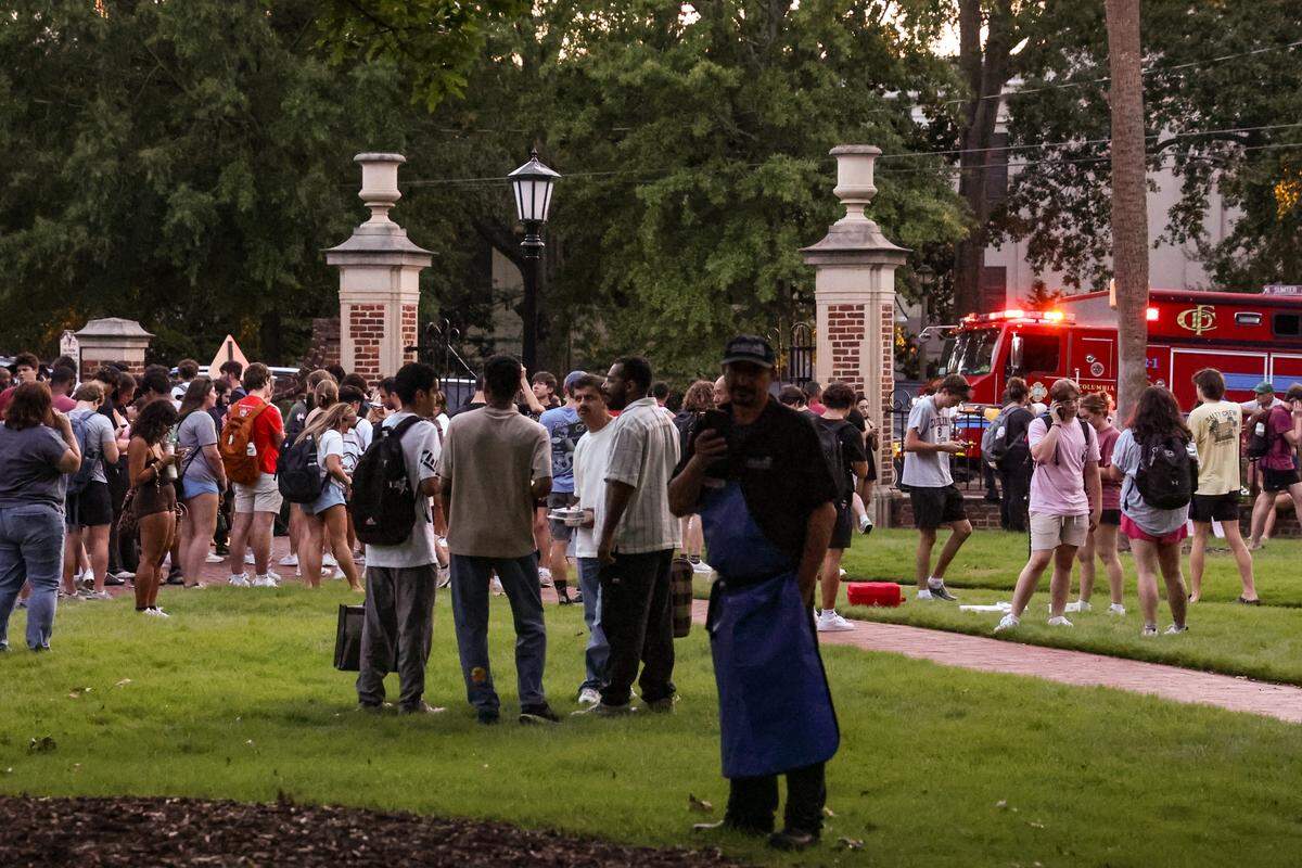 Students and staff congregate on the USC Horseshoe after being evacuated from the Russell House after reports of sounds of gunfire on the University of South Carolina campus at the Thomas Cooper Library on Sunday, Aug. 24, 2025.