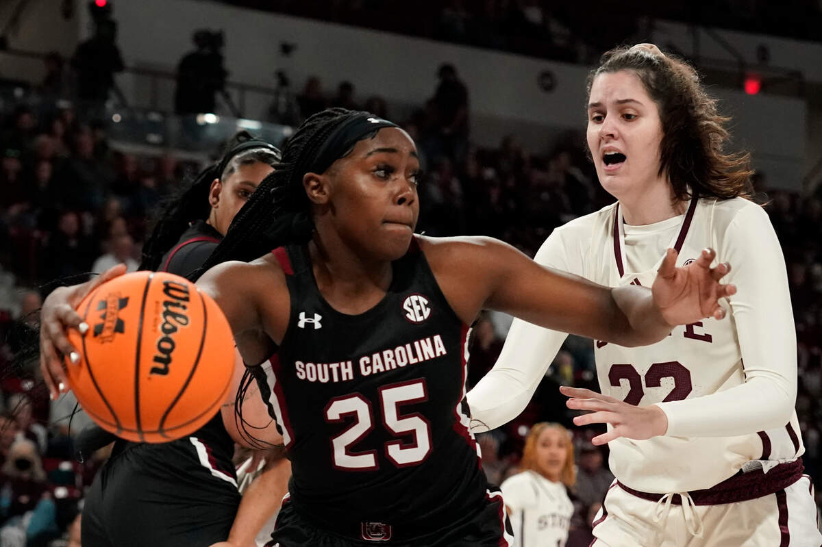 South Carolina guard Raven Johnson (25) pushes away from Mississippi State center Charlotte Kohl (22) during the first half of an NCAA college basketball game in Starkville, Miss., Sunday, Jan. 8, 2023. (AP Photo/ogelio V. Solis)
