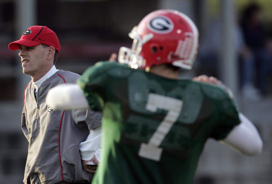 From December 2016: Georgia quarterback coach Mike Bobo, left, watches as quarterback Matt Stafford warms up during practice. Mark Richt shocked Georgia fans when he passed on the play-calling duties to assistant coach Bobo for the season-ending win over Georgia Tech. Bobo will continue his play-calling duties in the Dec. 30 Chick-fil-A Bowl football game against Virginia Tech.