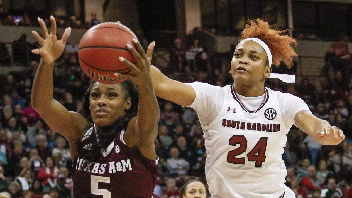 South Carolina's Lele Grissett (24) and Texas A&M's Anriel Howard (5)  go for a loose ball during the second half of action in the Colonial Life Arena on 12/31/17