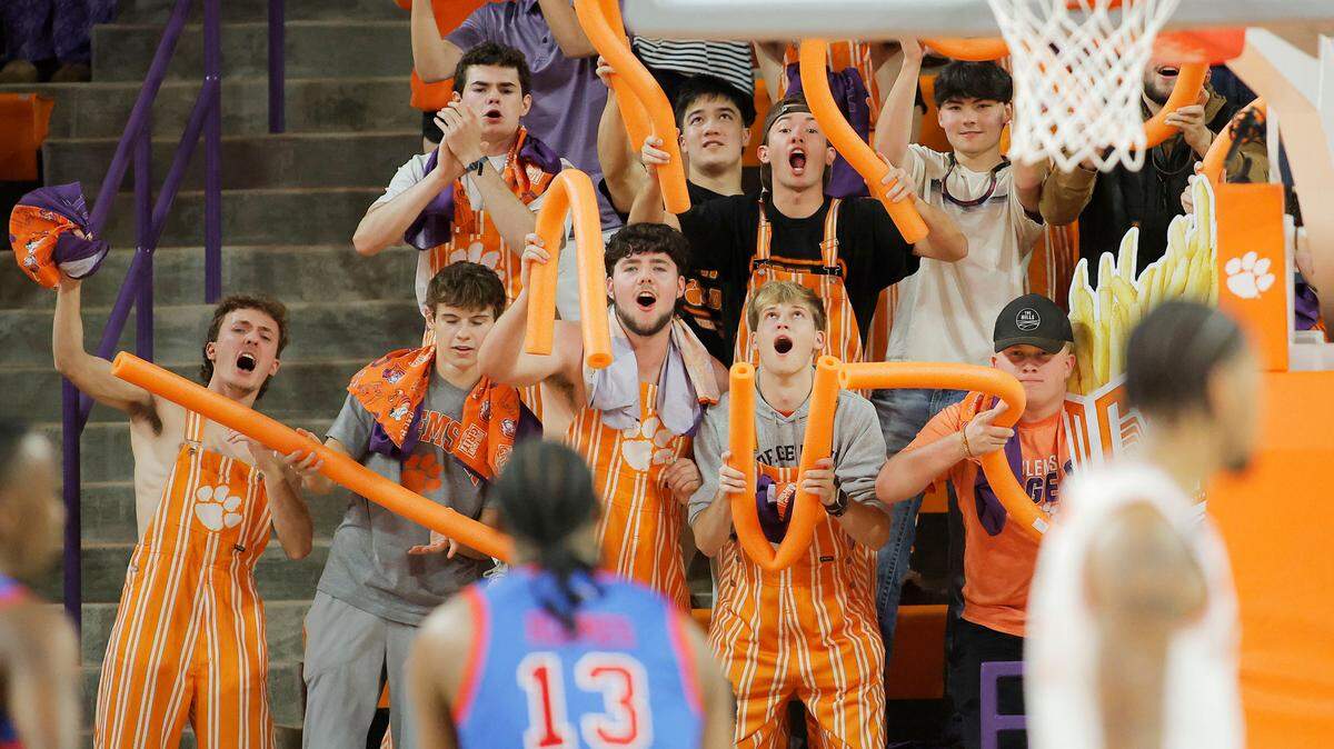 Clemson men’s basketball fans wave orange pool noodles as SMU forward Mitchell Holmes shoots a free throw at Littlejohn Coliseum on Jan. 7, 2026.