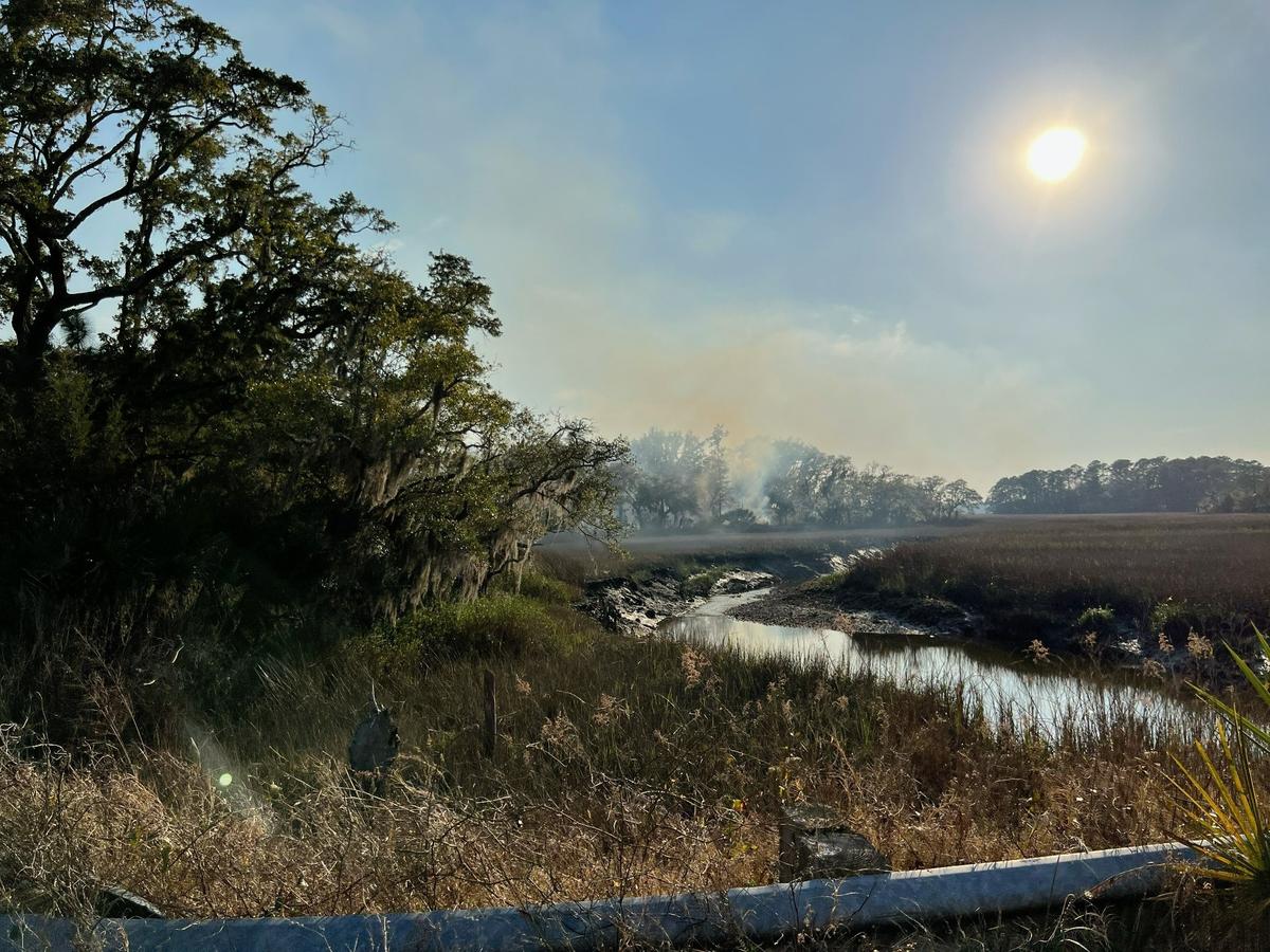 Smoke lingers in the sky hours after a fighter jet crashed Thursday, March 3, 2022 on Coosaw Plantation, the family property of former South Carolina governor and congressman Mark Sanford.