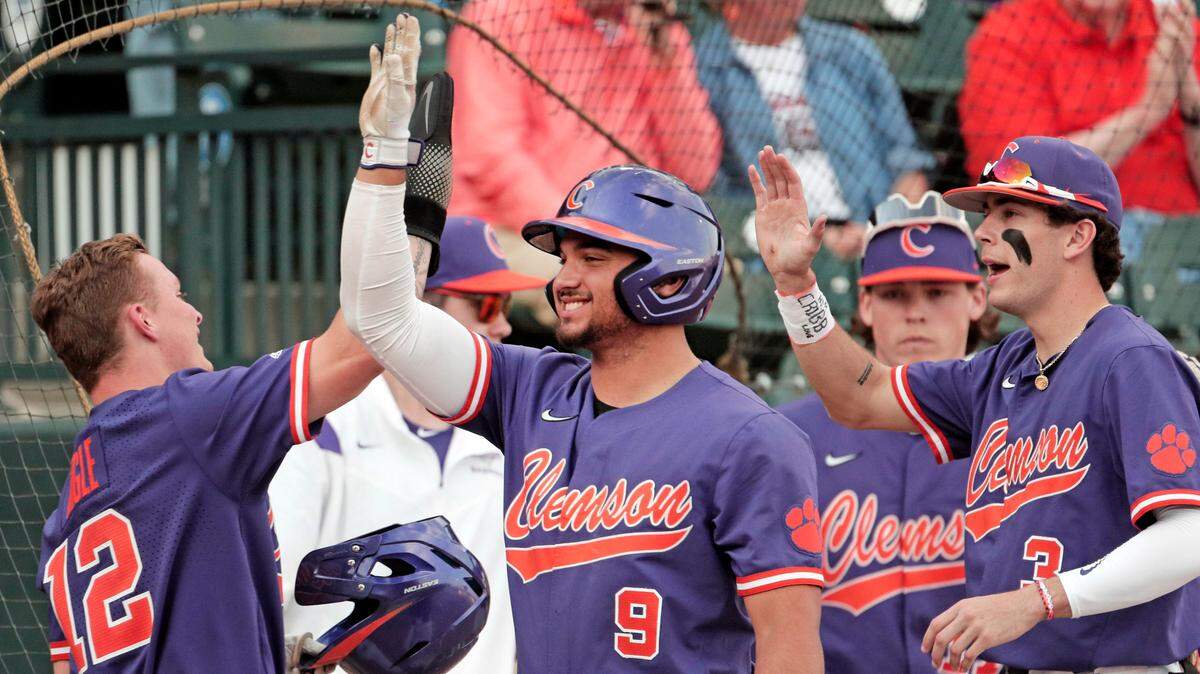 Clemson sophomore Cooper Ingle (12) celebrates with his team after scoring a run against South Carolina on Saturday, March 5, 2022.