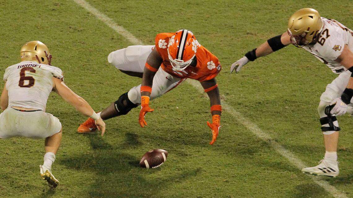 Clemson defensive end K.J. Henry (5) picks up a fumble by Boston College quarterback Dennis Grosel (6) to save the game during late, fourth-quarter action in Clemson, S.C. on Saturday, Oct. 2, 2021. (Travis Bell/SIDELINE CAROLINA)