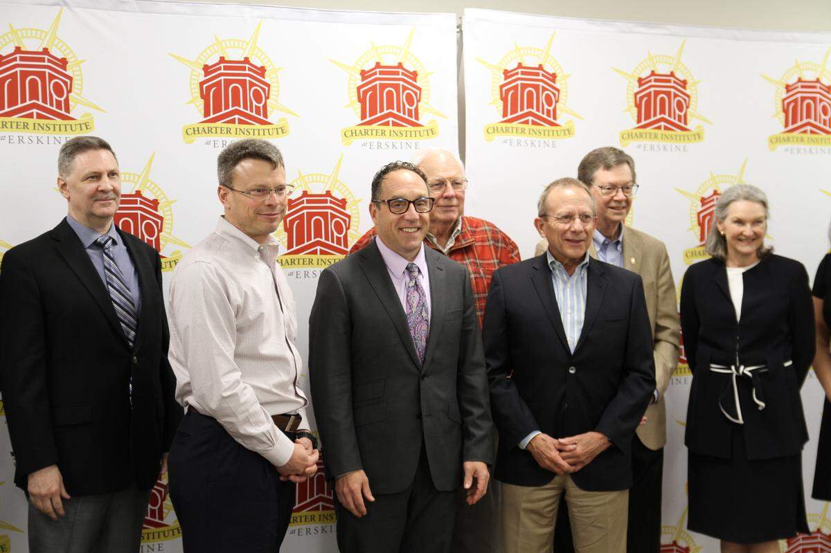 Officials with the Charter Institute at Erskine pose with members of Ascent Classical Academies during an April 2024 board meeting where Ascent was approved to open several new charter schools in South Carolina. Derec Shuler, executive director of Ascent Classical Academies, is second from left.