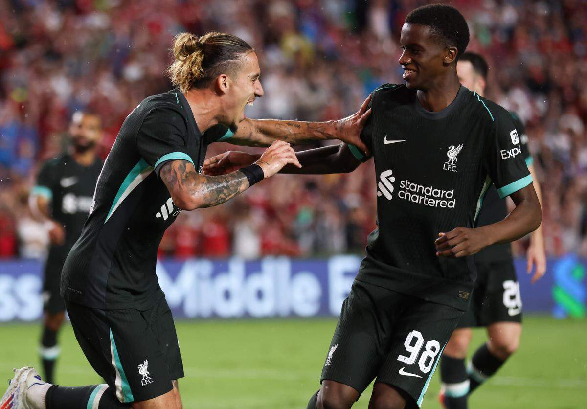 Liverpool defender Kostas Tsimikas (21) celebrates with teammate midfielder Trey Nyoni (98) after scoring during the Rivals in Red International Friendly soccer match between Manchester United and Liverpool in Columbia on Saturday, August 3, 2024.