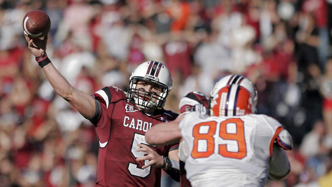 South Carolina quarterback Stephen Garcia, makes a pass down field, as he gets protection from Clemson defensive tackle Miguel Chavis during the second half of their NCAA college football game, Saturday, Nov. 28, 2009, at Williams-Brice Stadium, in Columbia, S.C. (AP Photo/Brett Flashnick)