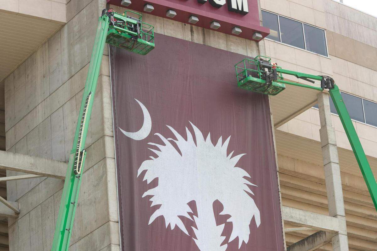 A new banner is placed at Williams-Brice Stadium on Saturday, July 24, 2021. The new banner says “welcome home” and features a palmetto tree and crescent moon in the University of South Carolina’s school colors.