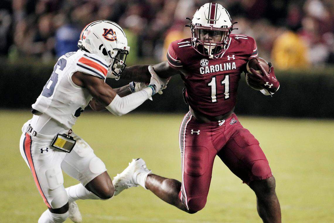 South Carolina Gamecocks running back ZaQuandre White (11) fends off Auburn’s Jaylin Simpson 36 on Saturday, November 20, 2021.