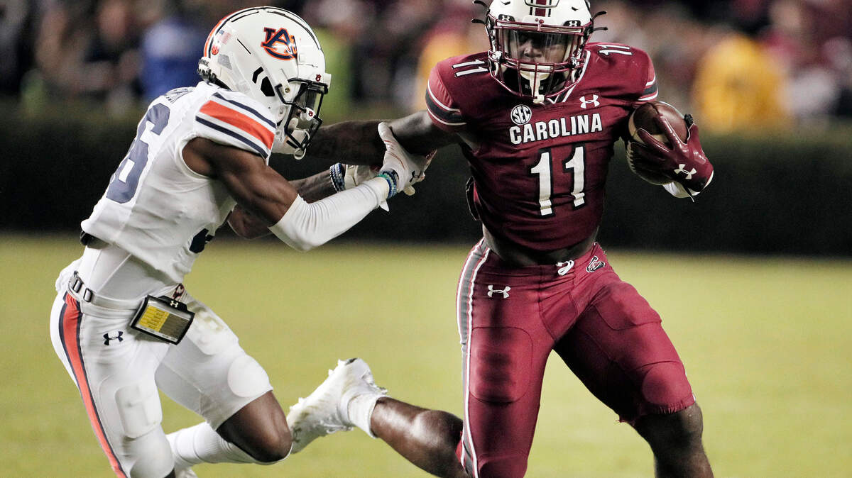 South Carolina Gamecocks running back ZaQuandre White (11) fends off Auburn’s Jaylin Simpson 36 on Saturday, November 20, 2021.
