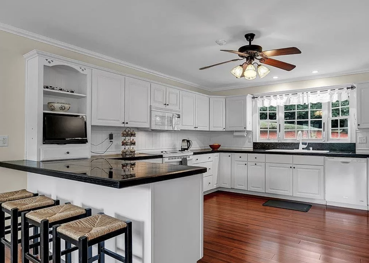 The kitchen opens to a dining area that looks out onto the pond.
