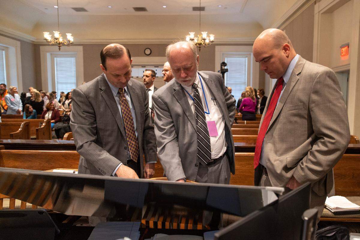 From left, South Carolina attorney general Alan Wilson, Don Zelenka and John Conrad look at an aerial photo of the Moselle property in the double murder trial of Alex Murdaugh at the Colleton County Courthouse in Walterboro, Thursday, Feb. 2, 2023. Andrew J. Whitaker/The Post and Courier/Pool