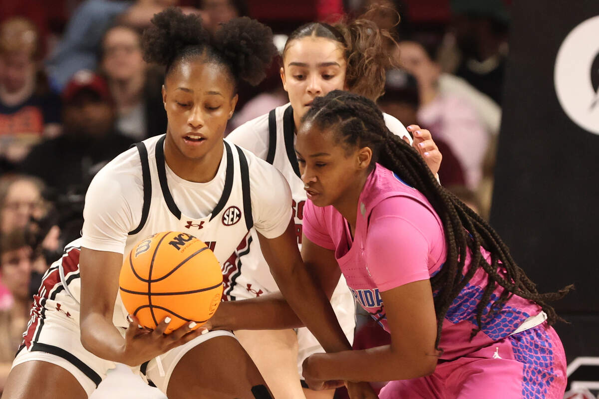 University of South Carolina’s Joyce Edwards (8) pops the ball away from Florida’s Eriny Kindred (21) during the first half of action in the Colonial Life Arena on Thursday, Feb. 13, 2025.