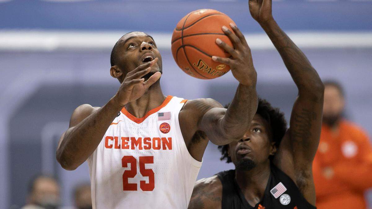 Clemson’s Aamir Simms (25) drives to the basket against Miami’s Nysier Brooks (3) during the second half on Wednesday, March 10, 2021 during the ACC Tournament at the Greensboro Coliseum in Greensboro, N.C.
