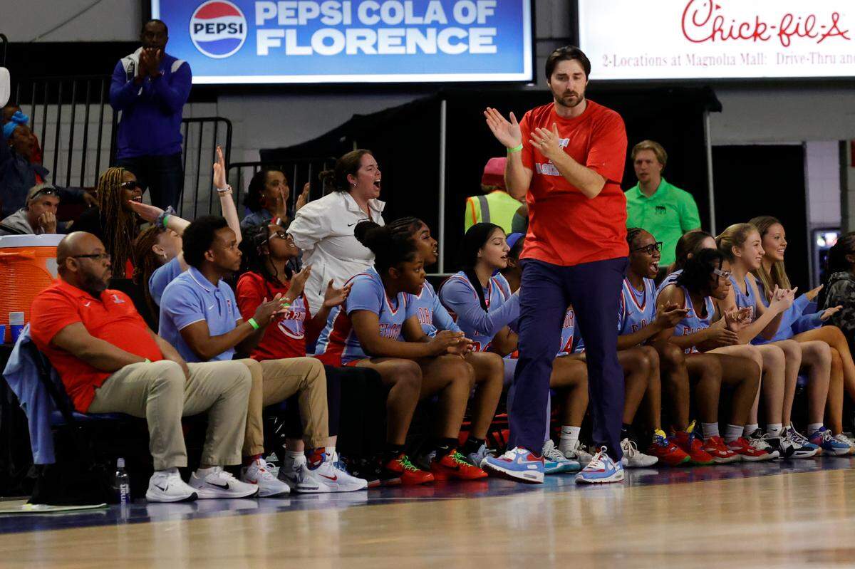 AC Flora’s head coach, Jacob Thompson, applauds a play during the first half of action against Riverside at the Florence Center in the Class 4A girls basketball championship game on Saturday, March. 2, 2024.