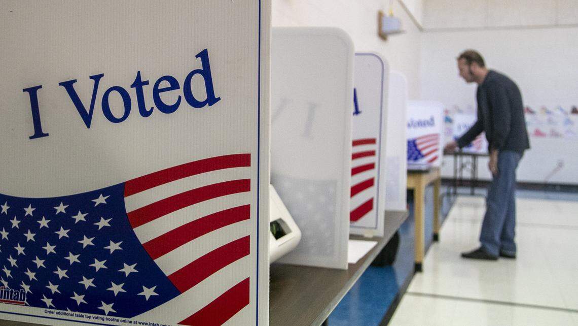 Voter Jason Puckett casts a ballot in Columbia in Nov. 2019.