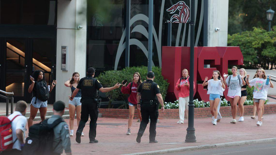 Students get directions from Law enforcement officials after reports of the sounds of gunfire at The University of South Carolina, at the Thomas Cooper Library on Sunday, August 25, 2025.