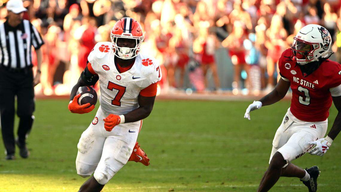 Oct 28, 2023; Raleigh, North Carolina, USA; Clemson Tigers running back Phil Mafah (7) runs the ball as North Carolina State Wolfpack cornerback Aydan White (3) defends during the second half at Carter-Finley Stadium.