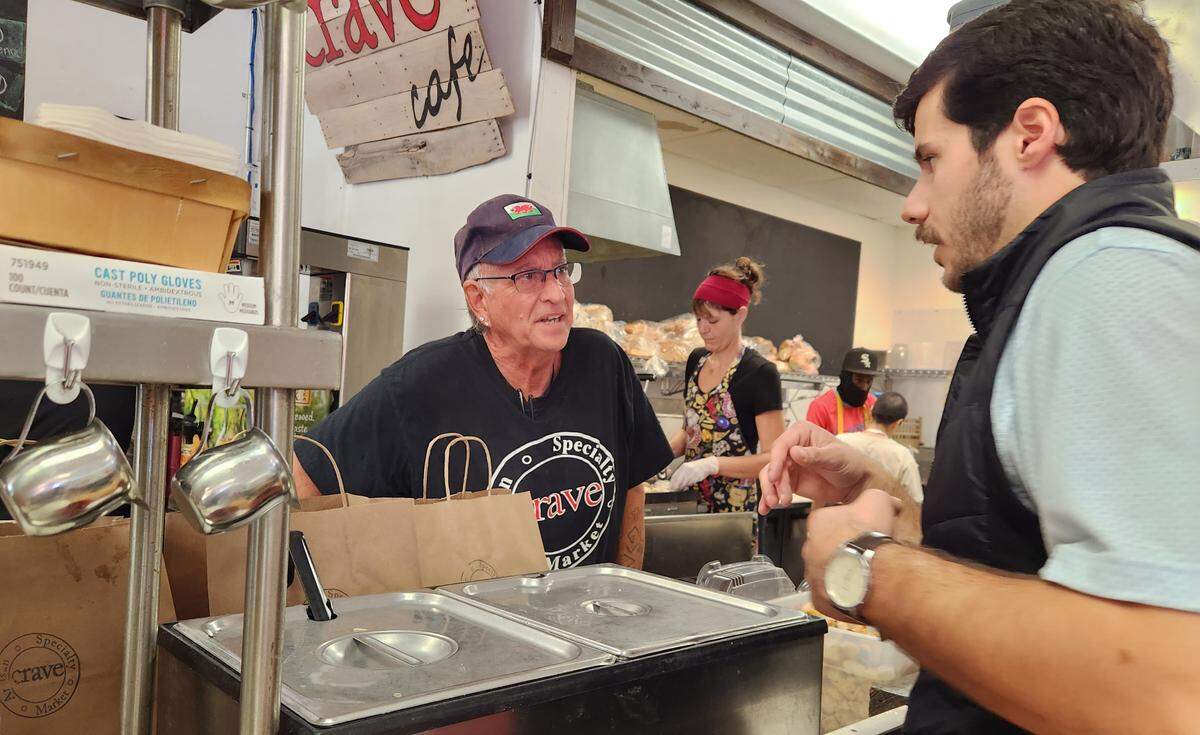Crave employee Benjamin Bodie, left, and co-owner Louis Williams chat during a recent shift at the restaurant.