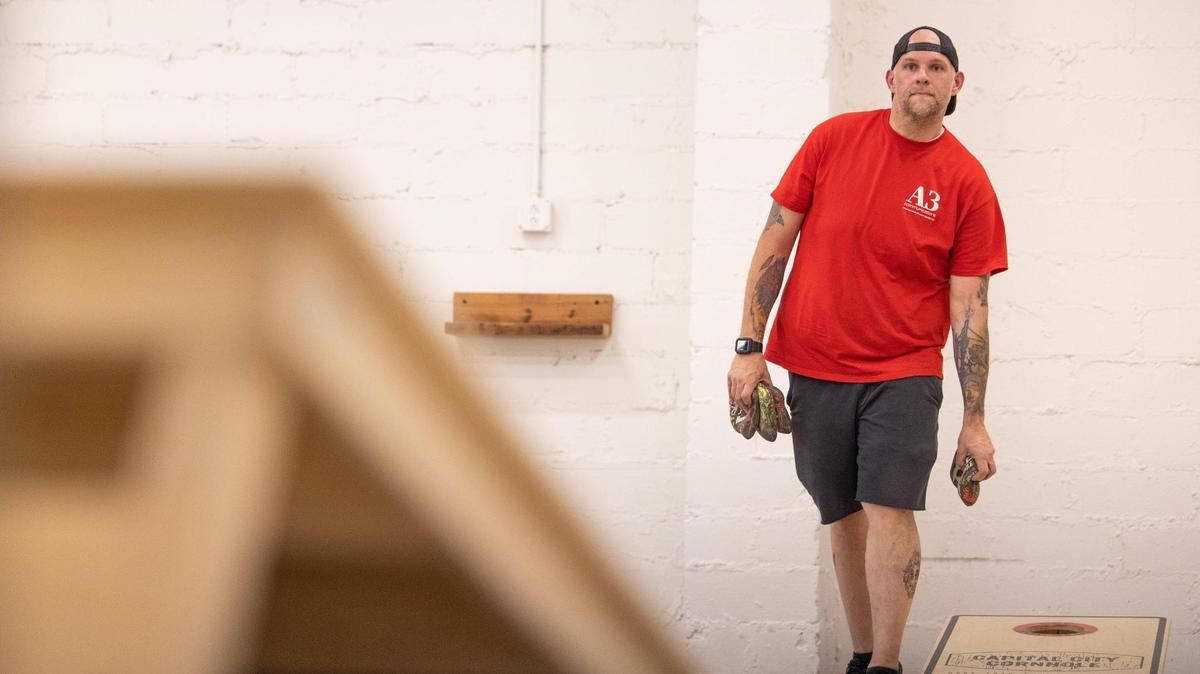 Chris Williamson practices cornhole at Capital City Cornhole in the North Main area. Williamson also competes in cornhole tournaments.