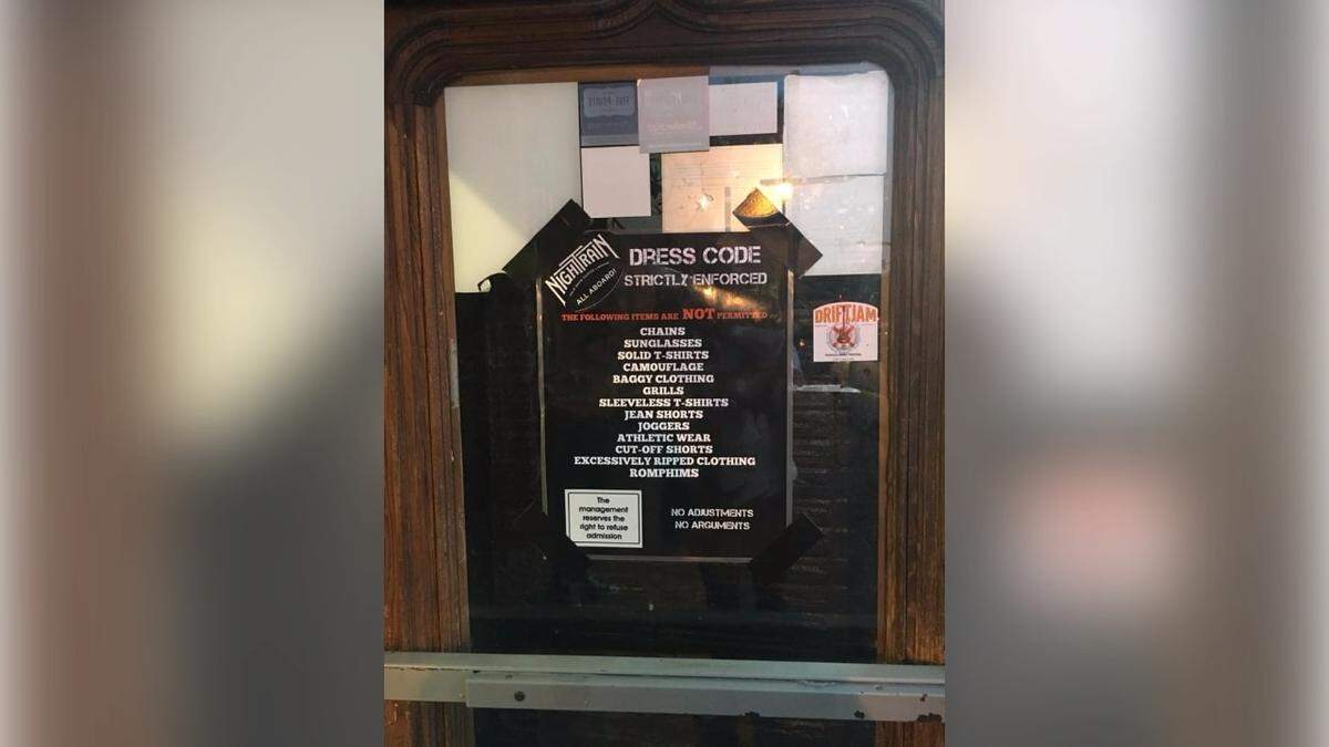A dress code that denied people entry for wearing chains, grills, solid colored t-shirts, and RompHims used to be posted at Moosehead Saloon.
