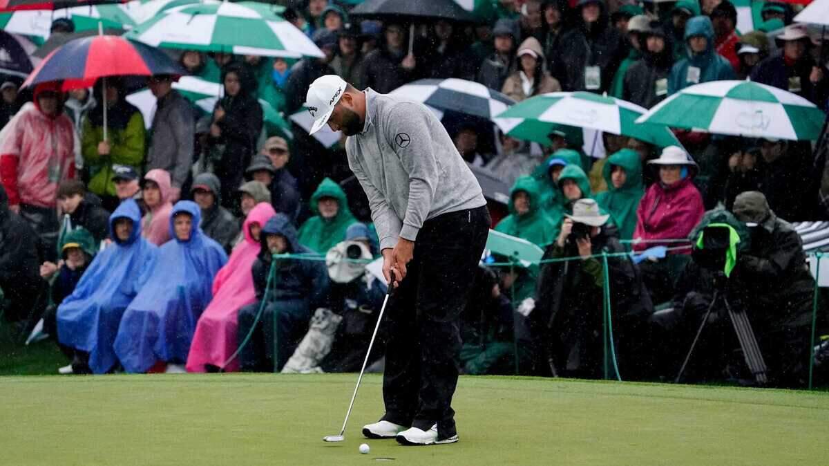 Jon Rahm putts on the 18th green during the second round of The Masters golf tournament.