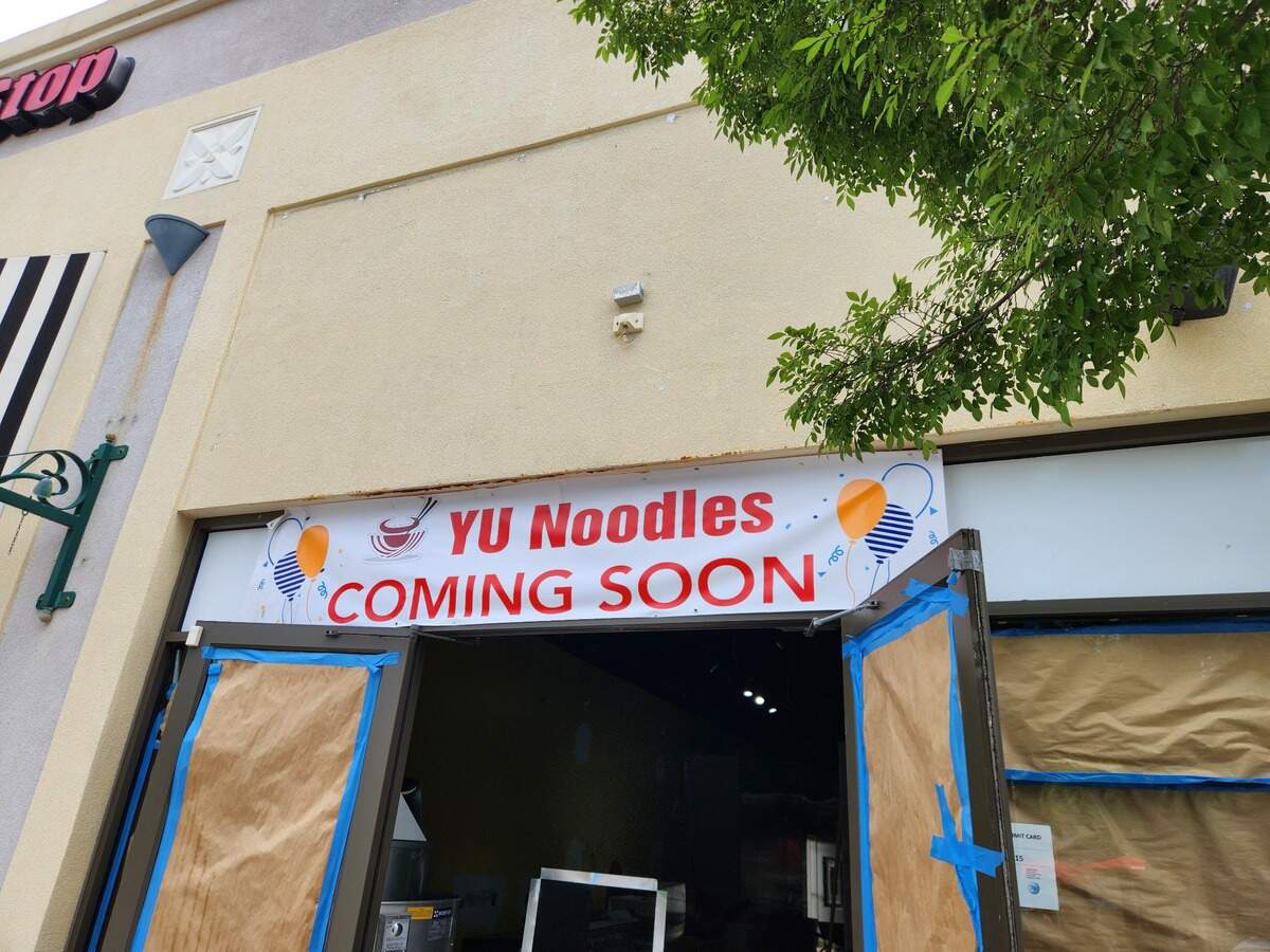A restaurant called Yu Noodles has a banner up saying it is coming soon at the Village at Sandhill shopping area in northeast Columbia.