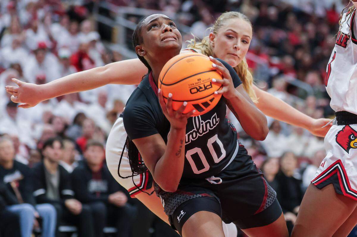 Ta'Niya Latson #00 of the South Carolina Gamecocks looks up to shoot against Laura Ziegler #0 of the Louisville Cardinals during the second half at KFC YUM! Center on December 4, 2025 in Louisville, Kentucky. 
