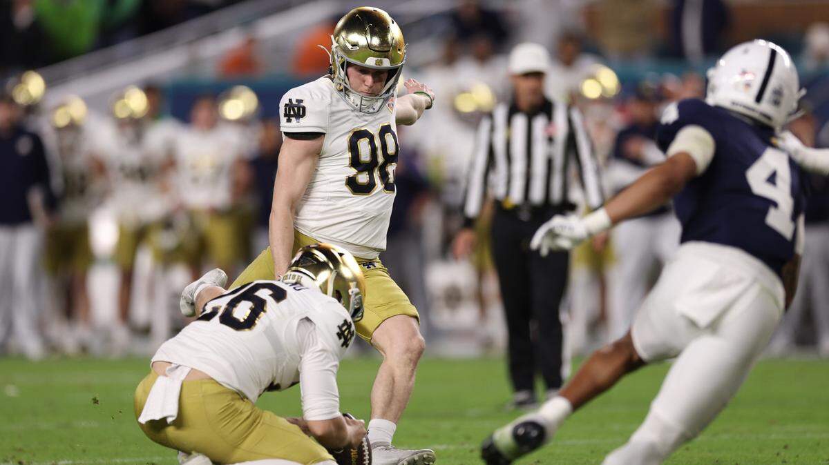 Notre Dame Fighting Irish place kicker Mitch Jeter (98) kicks a field goal in the second half against the Penn State Nittany Lions in the Orange Bowl at Hard Rock Stadium.