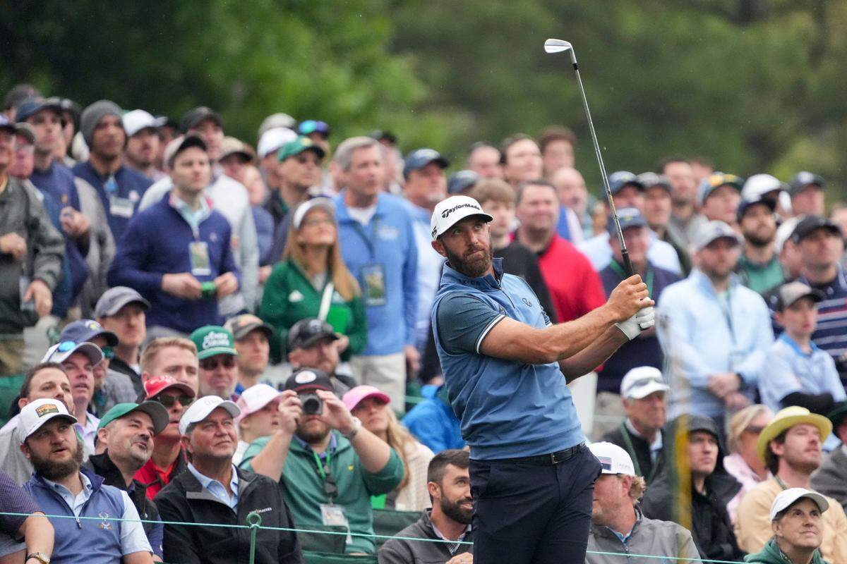 Dustin Johnson tees off on the 12th hole during a practice round Monday for The Masters golf tournament at Augusta National Golf Club.