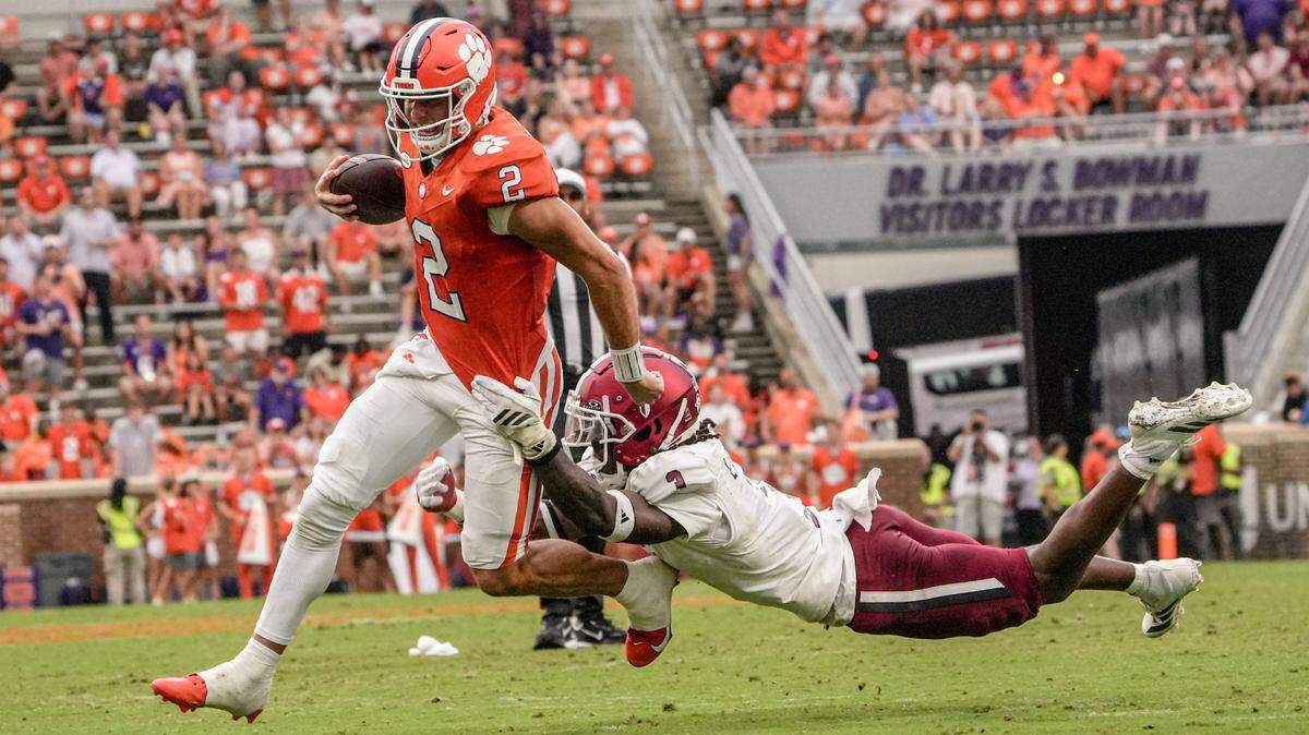 Clemson quarterback Cade Klubnik (2) runs by Troy Trojans linebacker Jordan Stringer (7) during the third quarter at Memorial Stadium in Clemson, S.C. Saturday, September 6, 2025.