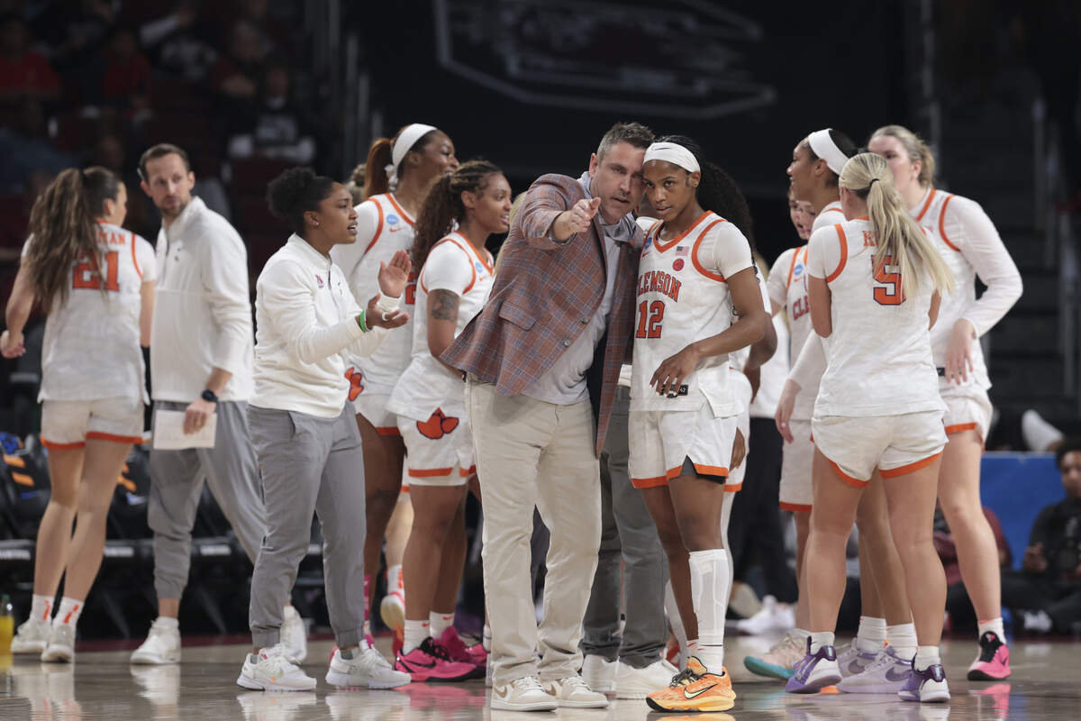 Clemson’s head coach Shawn Poppie talks to Mia Moore (12) during a timeout March 21 in an NCAA Tournament game against Southern Cal at Colonial Life Arena in Columbia.