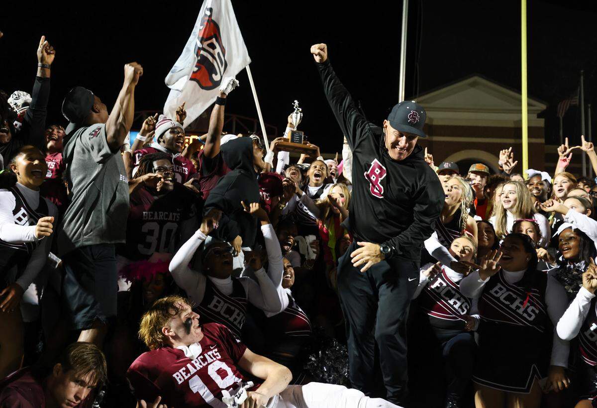 Brookland-Cayce head coach Rusty Charpia celebrates with players following his team’s win over Gilbert in Cayce on Friday, October 27, 2023.