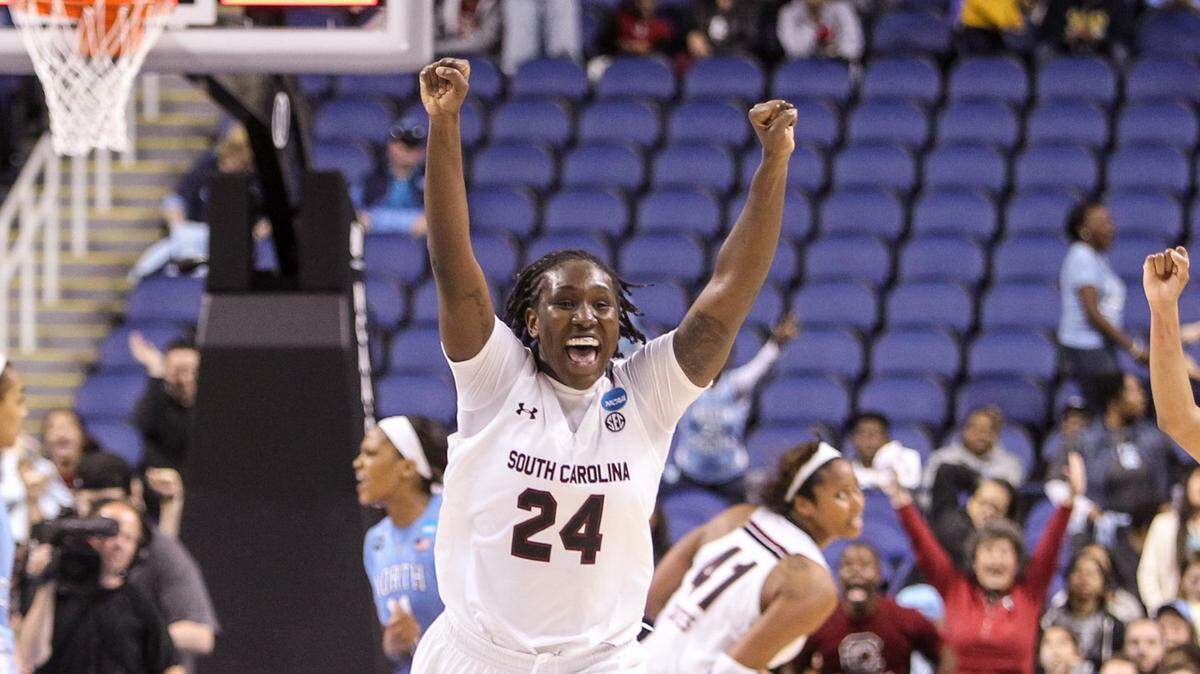 From March 27, 2015: South Carolina forward Aleighsa Welch (24) and guard Olivia Gaines (2) celebrate beating North Carolina during the second half of action in the NCAA Division 1 regional at the Greensboro Coliseum.