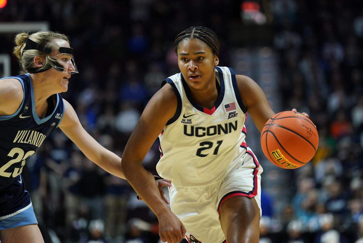 Mar 9, 2025; Uncasville, CT, USA; UConn Huskies forward Sarah Strong (21) drives the ball against Villanova Wildcats guard Maddie Burke (23) in the first half at Mohegan Sun Arena.