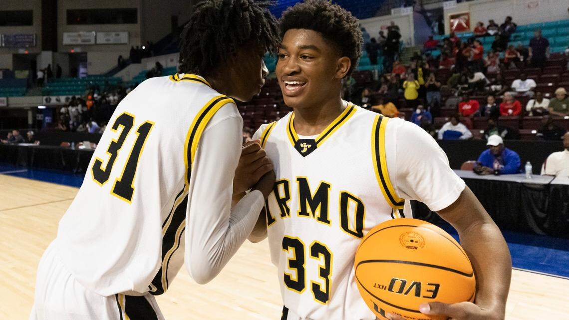 Brandon Crawford (31) and teammate Aaron Brand Jr. of Irmo celebrate their 54-38 win over Hartsville at the Florence Center in Florence on Friday, February 24, 2023.