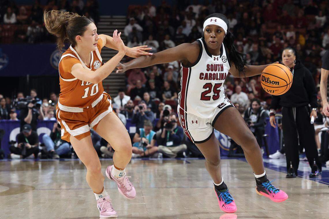 University of South Carolina’s Raven Johnson (25) fends off Texas’ Shay Holle (10) during the second half of action in the SEC Tournament at the Bon Secours Wellness Arena in Greenville on Sunday, March 9, 2025.