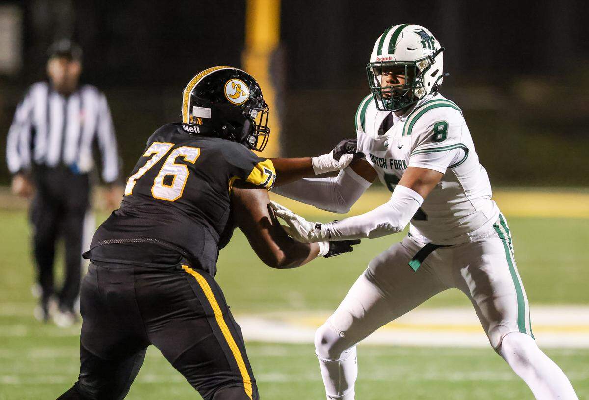 Julian Walker (8) of Dutch Fork and Bryson Moore (76) of Irmo battle for position during Irmo’s game against visiting Dutch Fork in Columbia on Friday, October 31, 2025.