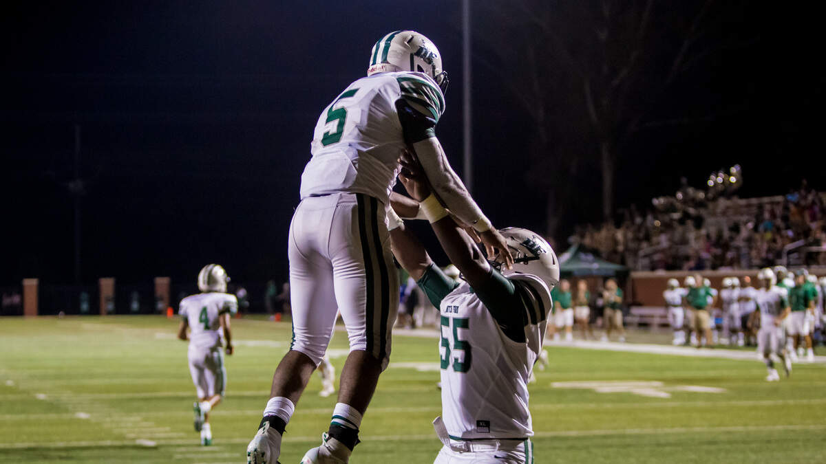 Dutch Fork Silver Foxes Ron Hoff (5) and Dutch Fork Silver Foxes offensive lineman Jalen Mcduffie (55) celebrate a Hoff touchdown during the game between Dutch Fork High at River Bluff High School. The Silver Foxes hosted White Knoll on Thursday night.