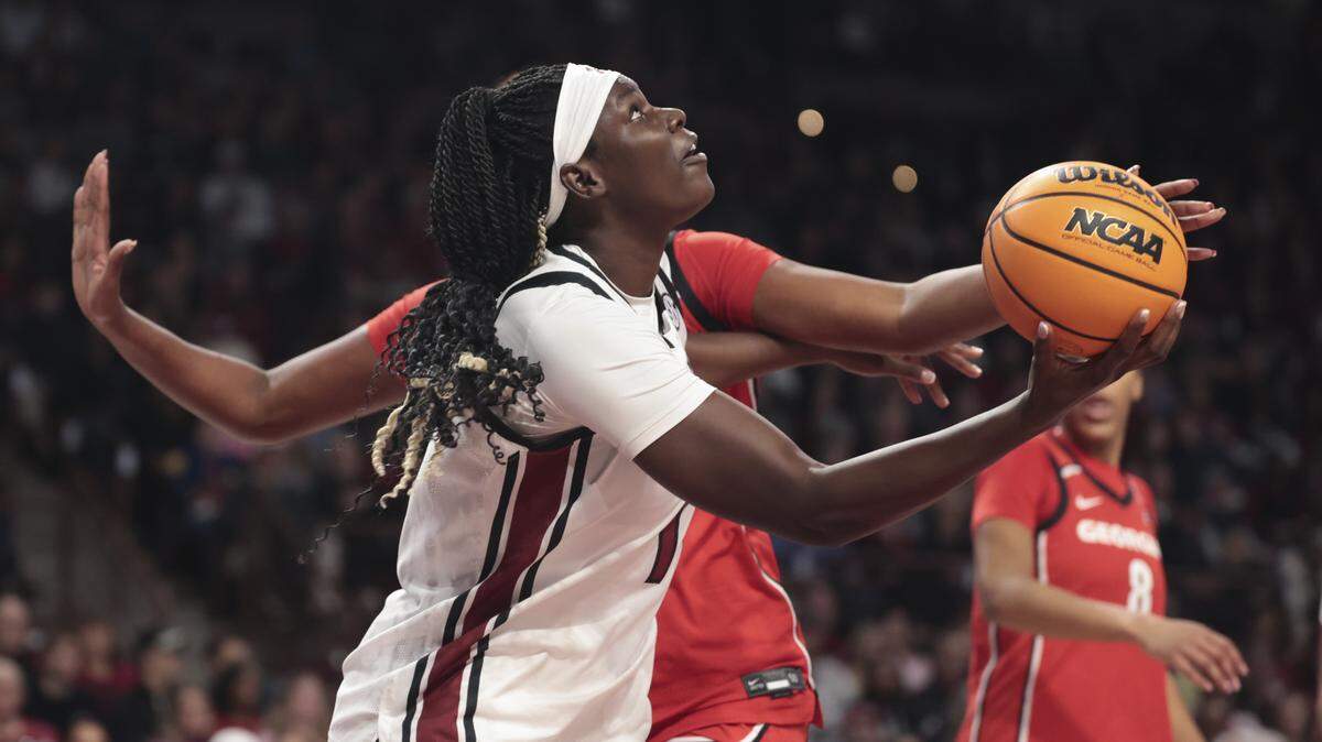 South Carolina's Madina Okot (11) looks to shoot as Georgia's Aicha Ndour (21) pressures during the first half of action of their women's basketball game against Georgia at Colonial Life Arena on Sunday, Jan. 11, 2026.