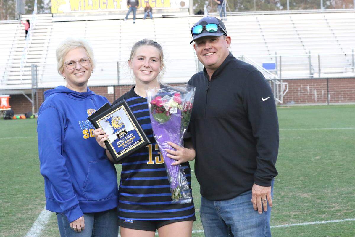 Lexington soccer player Maggie Heffernan, middle, poses with her mother Robyn and and father Sean on Senior Night. Heffernan won the reader’s choice for The State Newspaper Girls Soccer Player of Year and was the paper’s co-player of the year for 2024.