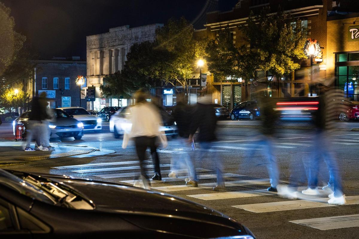 Students, locals and visitors walk from club to club in the Vista neighborhood in Columbia, South Carolina on Friday, November 18, 2022. Students and business owners have noticed a shift in Columbia’s nightlife scene.