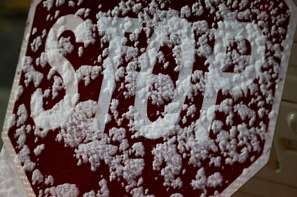 Snow sticks to a stop sign at Franks Car Wash in Forest Acres as a dusting of snow blankets Columbia on Tuesday, Jan. 21, 2025.