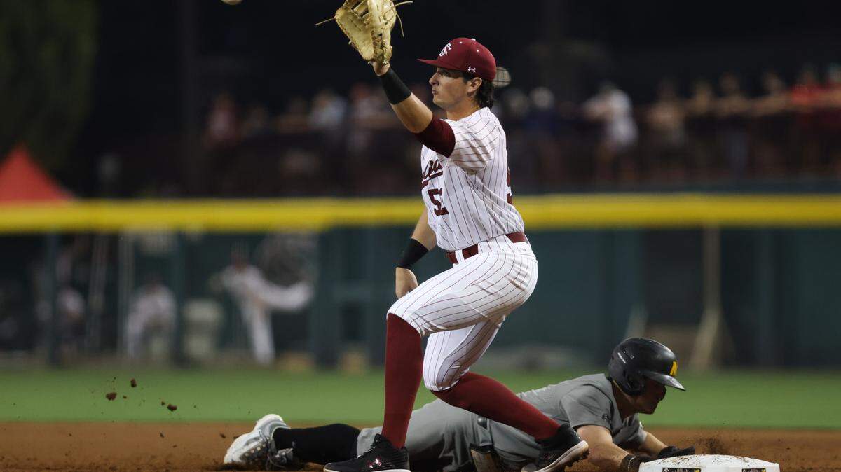 Missouri infielder Cam Chick (6) dives safely back into first, ahead of the tag from South Carolina infielder Gavin Casas (52), during the Gamecocks’ game against Missouri at Founders Park in Columbia on Friday, March 24, 2023.